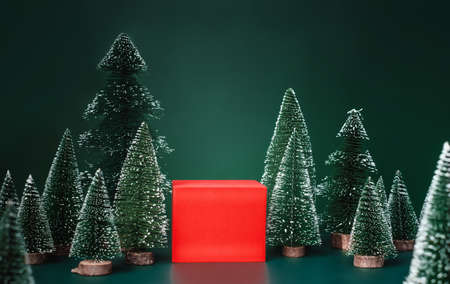 christmas tree group and red vivid product display block on green background.の写真素材