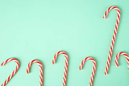 red candy cane group on pastel green backgroundの写真素材