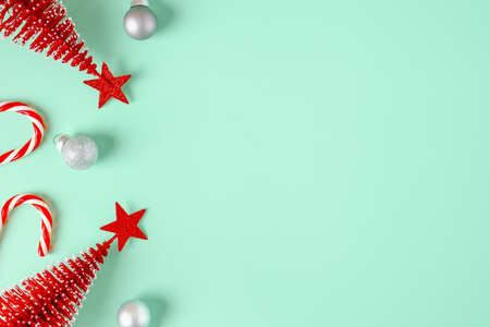 top view christmas ornament xmas tree,candy cane,bauble decor on pastel green backgroundの写真素材