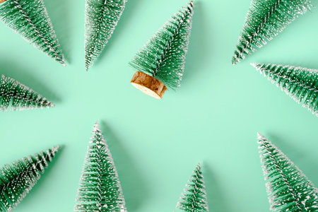 group of christmas tree lay on pastel green backgorund top viewの写真素材