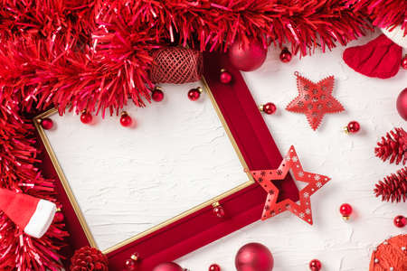 Christmas red picture frame and bauble decoration ornament on white concrete table backgroundの写真素材