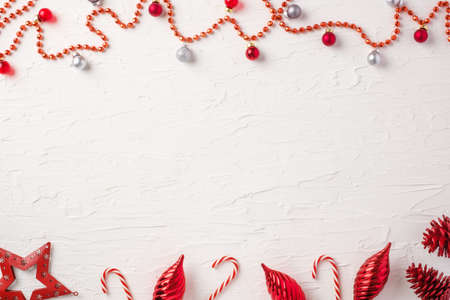 Christmas ball and tinsel and star decoration ornament on white concrete table backgroundの写真素材