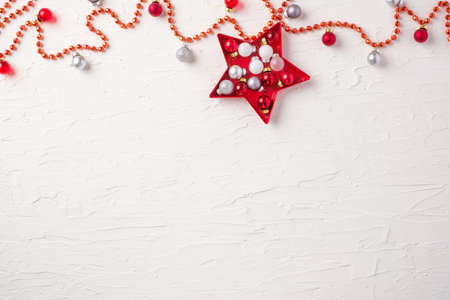 Christmas ball and tinsel and star decoration ornament on white concrete table backgroundの写真素材