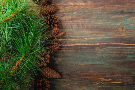 Christmas pine tree fir with pine cone decoration on vintage rustic wood table background