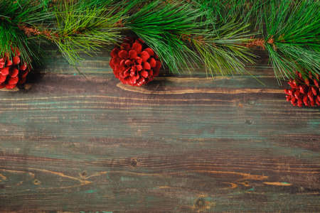 Christmas pine tree fir with pine cone decoration on vintage rustic wood table backgroundの写真素材