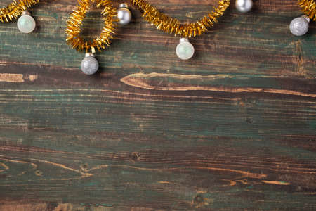 Christmas gold bauble and tinsel decoration ornament on table wood backgroundの写真素材