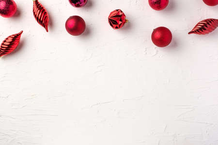 Christmas red bauble ball decoration on white pastel table backgroundの写真素材