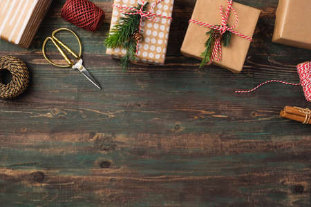 Handmade christmas gift box with brown paper decor with pine fir on wood table
