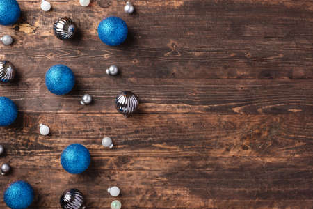 Christmas blue gift box and silver bauble decoration ornament on wood table backgroundの写真素材