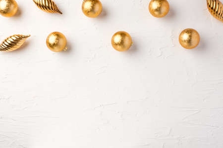 Christmas gold bauble ball decoration on white pastel table background