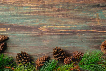 Christmas pine tree fir with pine cone decoration on vintage rustic wood table backgroundの写真素材