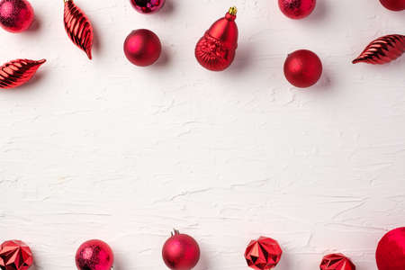 Christmas red bauble ball decoration on white pastel table backgroundの写真素材