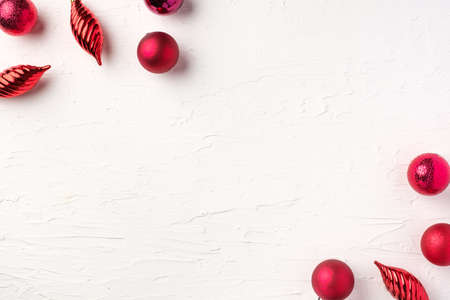 Christmas red bauble ball decoration on white pastel table backgroundの写真素材
