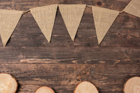 Christmas wood log plate and kraft flag on brown wooden tableの写真素材