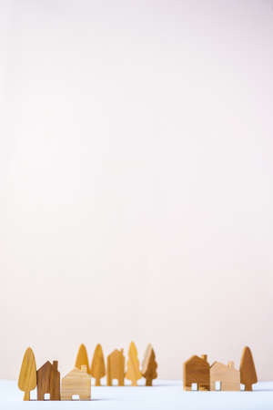 group of wood home toy village shape on white table peach backgroundの写真素材