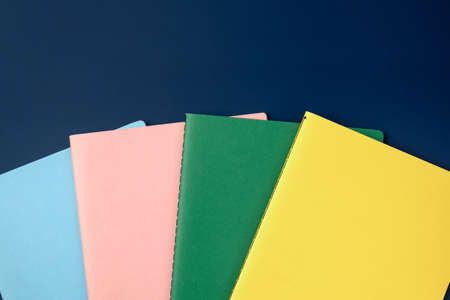 top view pastel notebook with pencil and stationery on navy blue table backgroundの写真素材