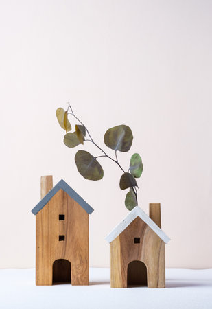 wood home toy craftmanship on white table and green wall with eucalyptus leafの写真素材