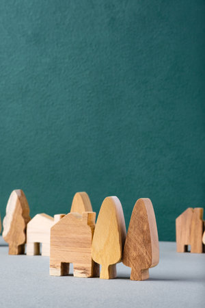 set of wooden house and tree decoration in village on grey floor and green backgroundの写真素材