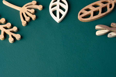 set of leaves engrave wooden on dark green table backgroundの写真素材