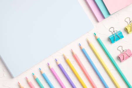 top view of pastel color pencil and file on white tableの写真素材