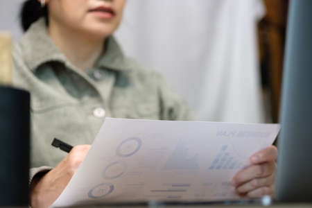 asisn woman presentation business diagram video conference meeting with colleage online with laptop at homeの写真素材