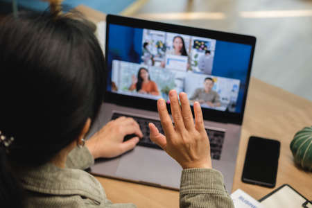 asisn woman video conference busienss meeting with colleage online with laptop at homeの写真素材