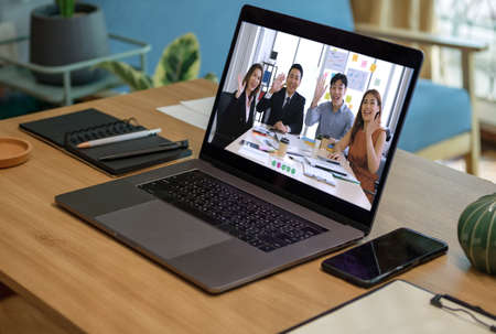 close up screen groupd of asian colleage video confernece business plan with laptop on table at homeの写真素材