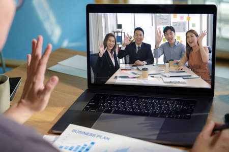 asisn woman video conference busienss meeting with colleage online with laptop at homeの写真素材