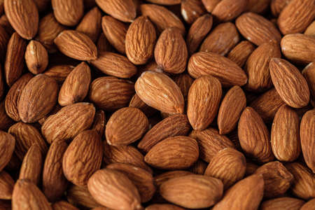 Almonds in wood bowl on wood table.Diet raw materialの写真素材