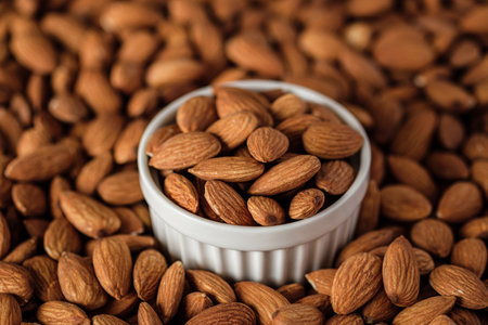 Almonds in wood bowl on wood table.Diet raw materialの写真素材