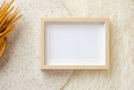 blank photo frame on white fur and marble stand backgroundの写真素材
