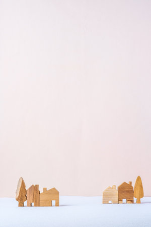 group of wood home toy village shape on white table peach backgroundの写真素材