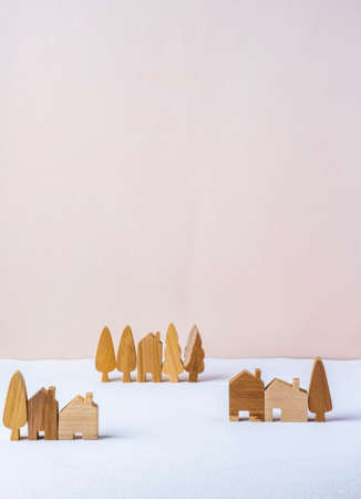 group of wood home toy village shape on white table peach backgroundの写真素材
