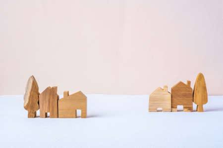 group of wood home toy village shape on white table peach backgroundの写真素材