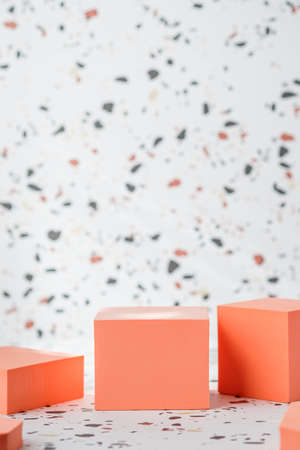 peach geometric pedestal on terrazzo background with summer sunlightの写真素材