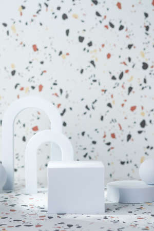 white geometric pedestal on terrazzo background with summer sunlightの写真素材