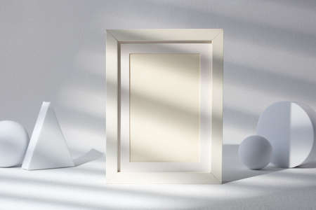 blank mockup photo freame with sunlight window at white studioの写真素材