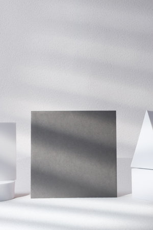 blank grey poster card with product display stand with sunlight in white studioの写真素材
