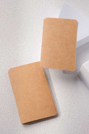 mockup blank Kraft business card on white block with sunlightの写真素材