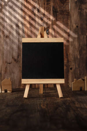 Blank blackboard with window sunlight shade on wood wall and tableの写真素材