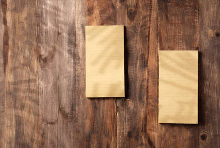 brown note paper to do list on wood wall and pencil box with sunlight