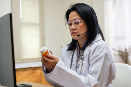 asian woman doctor visit patient video call online diagnose symptom at clinic