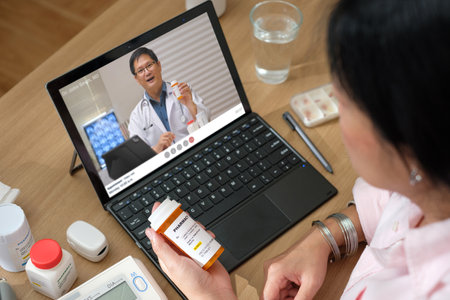 asian woman telemedicine doctor online visit with computer at homeの写真素材
