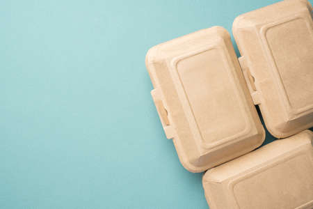 Recycle Eco-friendly disposable food container made of kraft paper on a green backgroundの写真素材