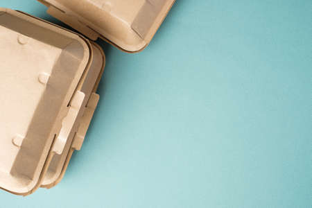 Recycle Eco-friendly disposable food container made of kraft paper on a green background