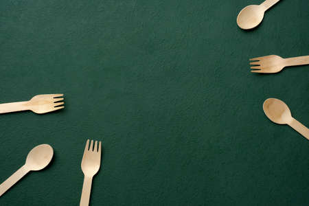 Plastic free set bamboo spoon and fork on dark green background.Zero waste disposable kitchen wareの写真素材