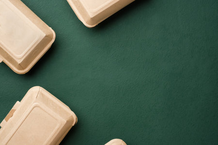 Recycle Eco-friendly disposable food container made of kraft paper on a green backgroundの写真素材