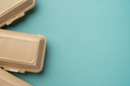 Recycle Eco-friendly disposable food container made of kraft paper on a green backgroundの写真素材