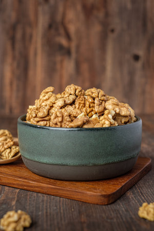 walnut in ceramic bowl on wooden tray in kiechen tableの写真素材