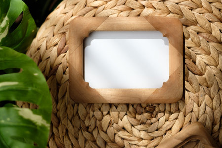 mockup wood photo frame on wicker stood with monstera with sunlight